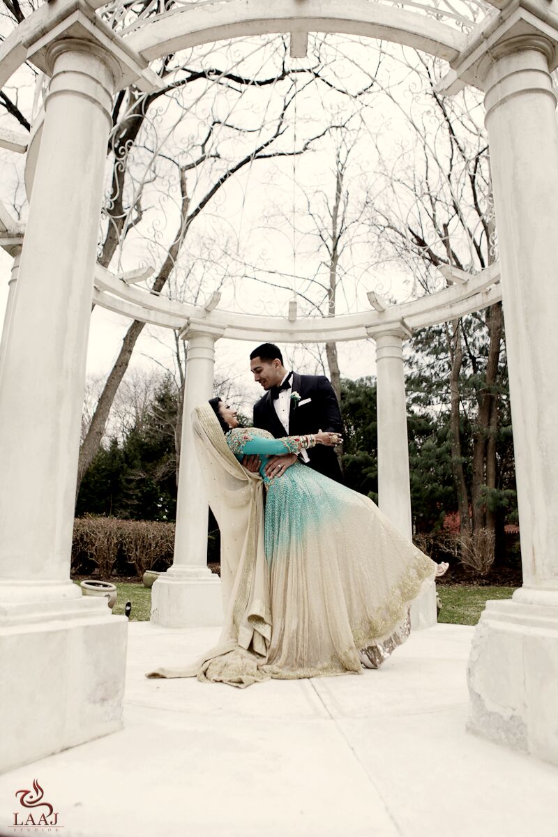 Couple dancing beneath a white gazebo in winter