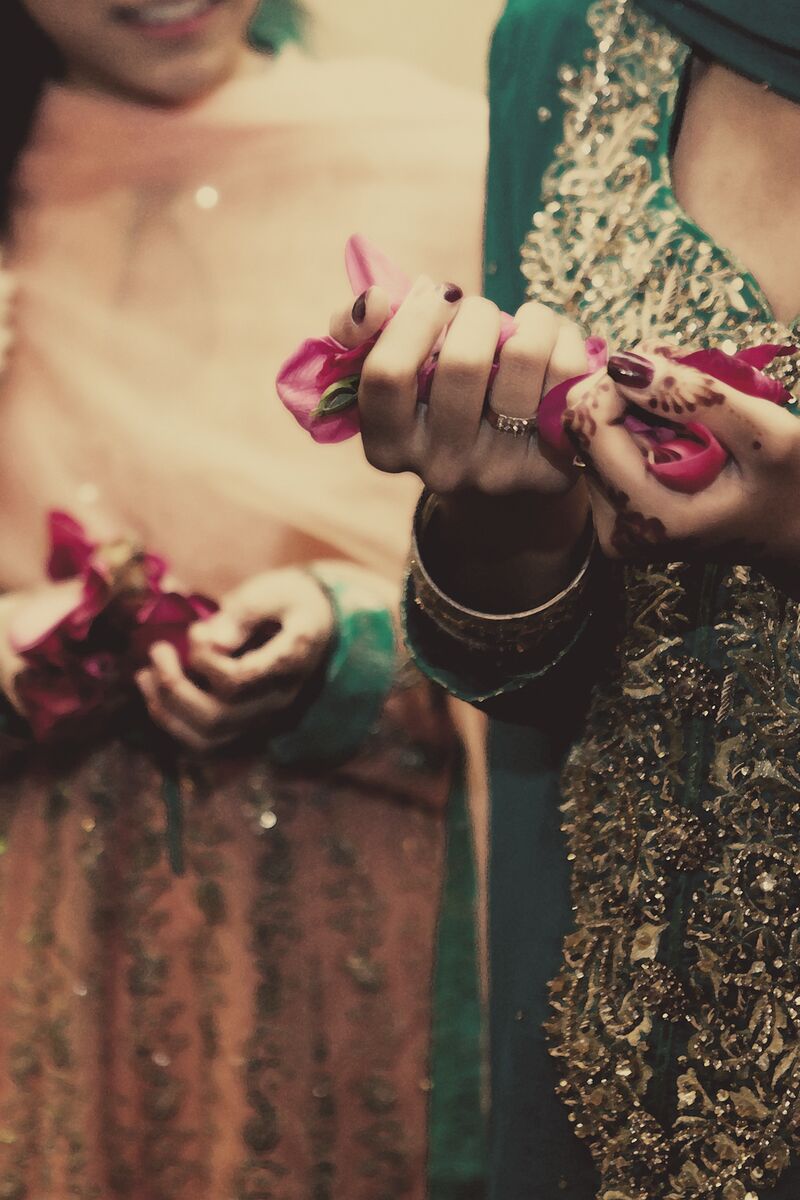 Rose petals in hennaed hands at the mehndi